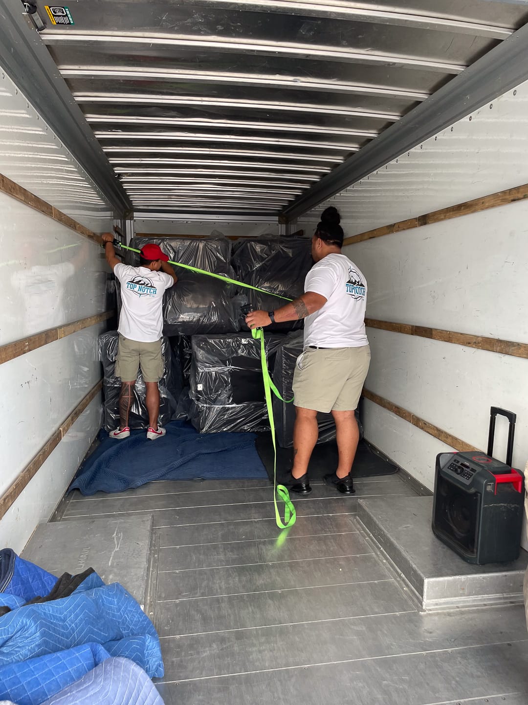 Strapping the load tight inside the trailer