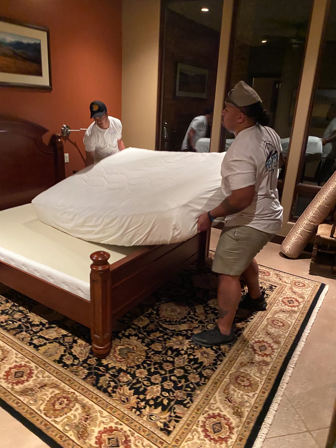 Crew setting the bed up in the new bedroom