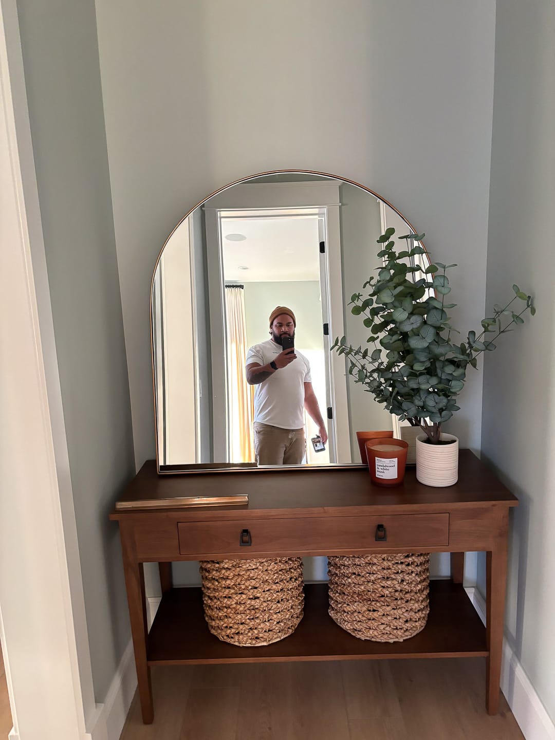 Placing an oversized arched mirror in the entryway